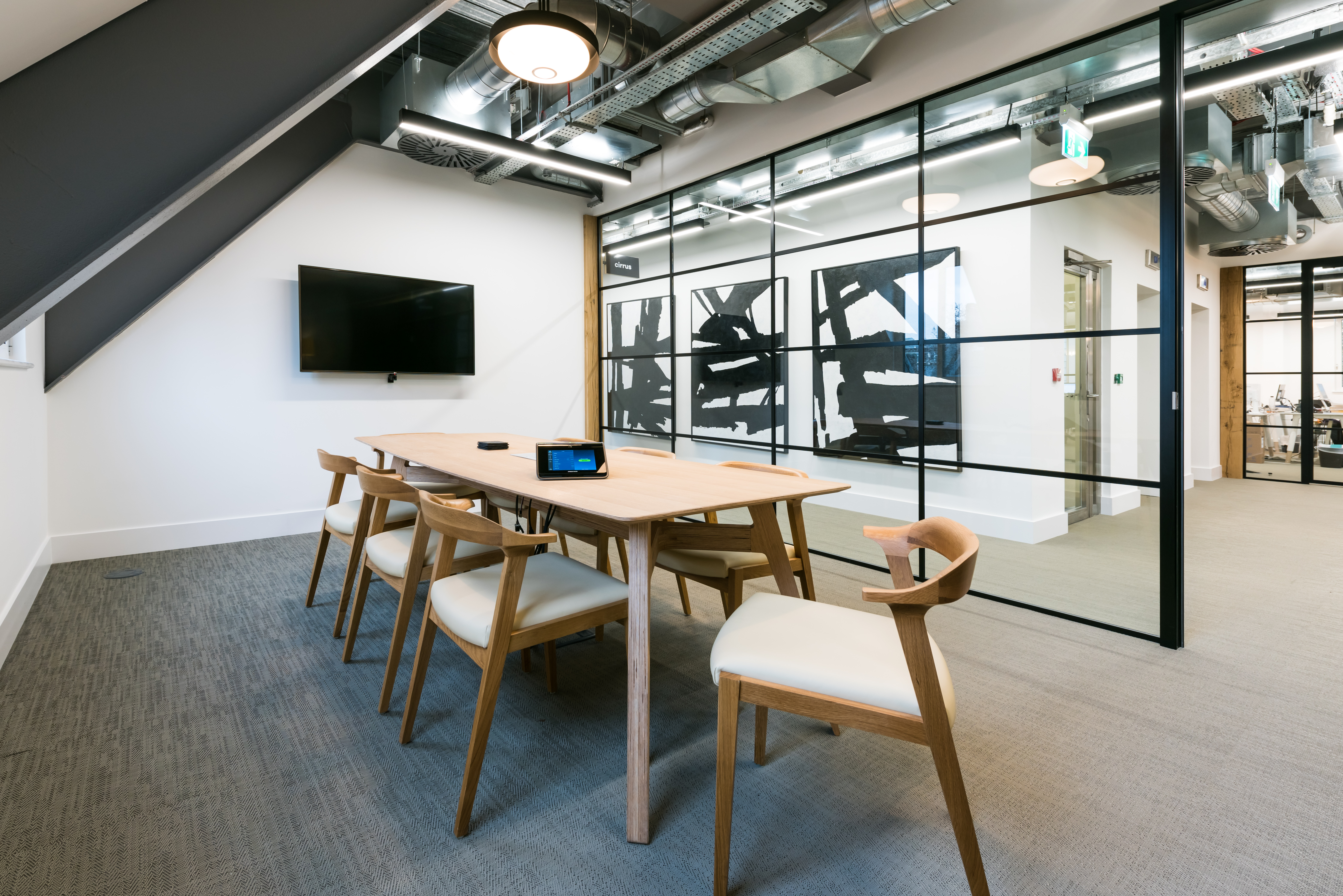 8 person meeting room at Dawn Capital with a modern and industrial designn