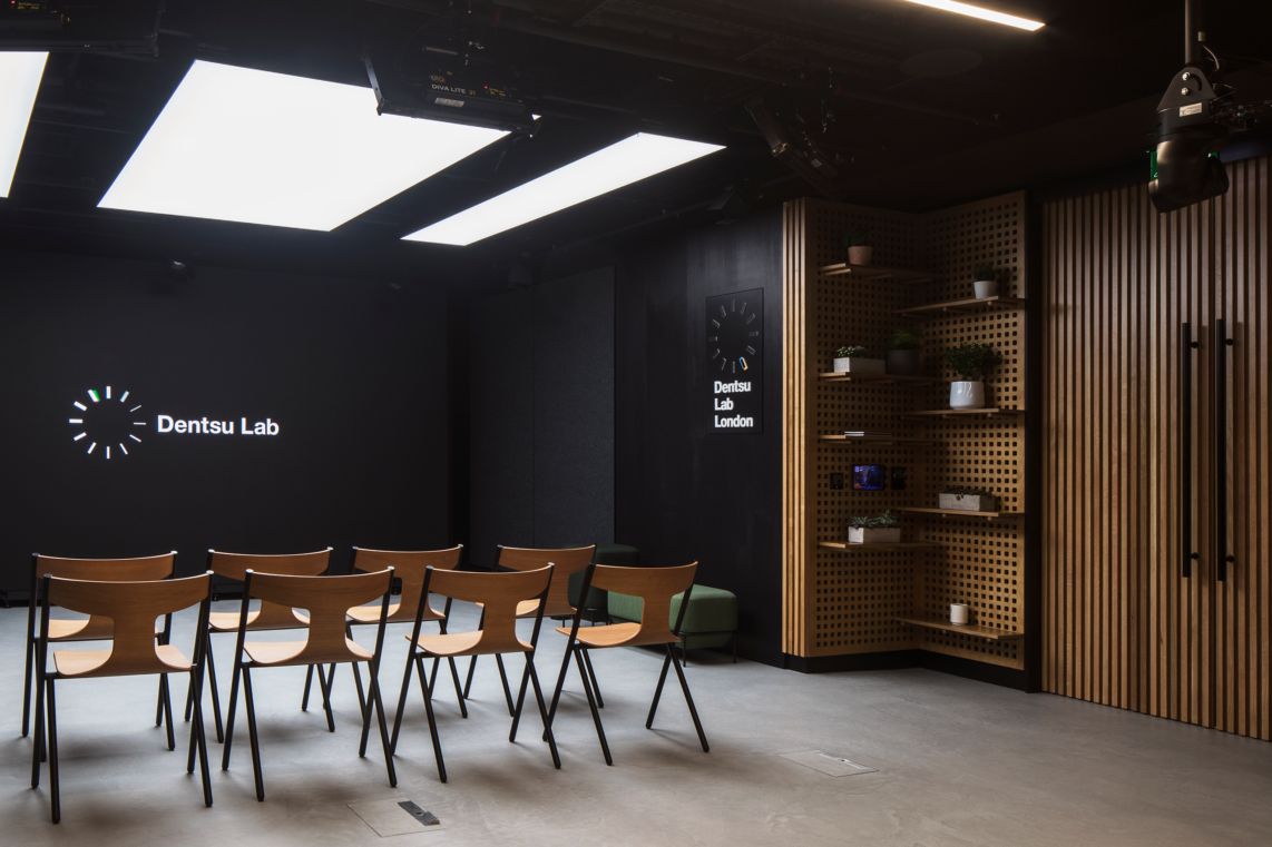 Dentsu lab with chairs facing the smart screen with natural material finishes